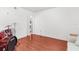Bedroom featuring hardwood floors, a drum set, and ample floor space at 10399 Elgin Blvd, Spring Hill, FL 34608
