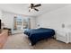 Spacious bedroom with a window, dresser, and a comfortable bed with blue bedding at 10399 Elgin Blvd, Spring Hill, FL 34608