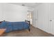 Simple bedroom with carpet flooring, neutral walls, and a door leading to an archway at 10399 Elgin Blvd, Spring Hill, FL 34608