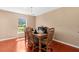 Comfortable dining room filled with light from a window overlooking the yard with a table set for six at 10399 Elgin Blvd, Spring Hill, FL 34608