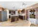 Charming kitchen featuring wood cabinets, a central island, and stainless steel appliances at 10399 Elgin Blvd, Spring Hill, FL 34608
