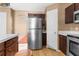 Spacious kitchen with wood cabinets, stainless steel appliances, and ample counter space for meal preparation at 10399 Elgin Blvd, Spring Hill, FL 34608