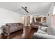 Inviting living room with hardwood floors, ceiling fan, and an open view to the kitchen, great for entertaining at 10399 Elgin Blvd, Spring Hill, FL 34608