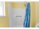 Shower stall features a seashell curtain, grab bar, and bright yellow walls at 10399 Elgin Blvd, Spring Hill, FL 34608