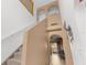 Staircase featuring carpeted stairs, with a view of the entryway and front door at 10399 Elgin Blvd, Spring Hill, FL 34608