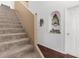 Staircase featuring carpeted stairs and a decorative niche on the wall at 10399 Elgin Blvd, Spring Hill, FL 34608