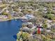 Aerial view showcasing community lake, clubhouse and pool, all conveniently located near residences at 10635 Timber Ln, Port Richey, FL 34668