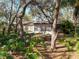 Home with lush green backyard, mature trees, and a sunroom for relaxing outdoors at 10635 Timber Ln, Port Richey, FL 34668