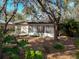 Charming backyard featuring mature trees, lush greenery and a bright sunroom at 10635 Timber Ln, Port Richey, FL 34668