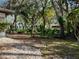 Backyard picture with mature trees, privacy, stone pavers, and a cozy sunroom at 10635 Timber Ln, Port Richey, FL 34668