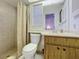 Bright bathroom featuring a walk-in shower, vanity with mirror, and ample lighting at 10635 Timber Ln, Port Richey, FL 34668