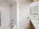 Clean bathroom featuring a white tiled shower/tub combination and a door to the outside at 10635 Timber Ln, Port Richey, FL 34668