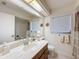 Bright bathroom with modern fixtures, large mirror, and a shower-tub combination at 10635 Timber Ln, Port Richey, FL 34668