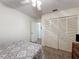 Simple bedroom with closet, ceiling fan and soft carpet, for a relaxing home environment at 10635 Timber Ln, Port Richey, FL 34668