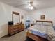 Cozy bedroom with rattan furniture and ceiling fan, perfect for relaxation and comfort at 10635 Timber Ln, Port Richey, FL 34668