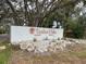 Elegant Timber Oaks community entrance sign with well-kept landscaping and attractive stone accents at 10635 Timber Ln, Port Richey, FL 34668
