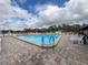 Well-maintained community pool featuring ample seating and a clear, sparkling swimming area at 10635 Timber Ln, Port Richey, FL 34668