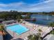 Aerial view of the community pool and lake, providing a resort-like experience at 10635 Timber Ln, Port Richey, FL 34668