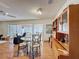 Open dining area with a glass table, stylish chairs, and built-in display cabinets at 10635 Timber Ln, Port Richey, FL 34668