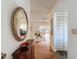 Welcoming foyer with hardwood floors, decorative mirror, and access to the living areas at 10635 Timber Ln, Port Richey, FL 34668