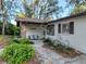 Inviting front porch with stone accents, seating, and lush landscaping at 10635 Timber Ln, Port Richey, FL 34668