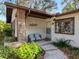 Charming front porch with seating area, landscaping, and direct access to the entrance at 10635 Timber Ln, Port Richey, FL 34668