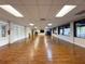 Spacious hall with hardwood floors, windows, and doors offering versatile use at 10635 Timber Ln, Port Richey, FL 34668