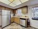 Cozy kitchen with light wood cabinetry, stainless steel appliances, and eat-in breakfast nook at 10635 Timber Ln, Port Richey, FL 34668