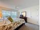 Spacious main bedroom with a large window, ceiling fan, dresser, and comfortable bed at 10635 Timber Ln, Port Richey, FL 34668
