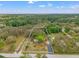 Stunning aerial view of property highlighting location, landscaping and home in natural wooded setting at 11326 Minnieola Dr, New Port Richey, FL 34654