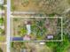 Overhead aerial view of property highlighting location, landscaping and wooded setting at 11326 Minnieola Dr, New Port Richey, FL 34654