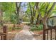 A charming backyard features a brick pathway and abundant trees with a shed at 11326 Minnieola Dr, New Port Richey, FL 34654