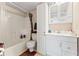 Cozy bathroom features a tub/shower combo, white vanity with storage, and wallpaper accents at 11326 Minnieola Dr, New Port Richey, FL 34654