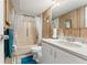 Well-lit bathroom features a vanity, tub/shower combo, and modern fixtures at 11326 Minnieola Dr, New Port Richey, FL 34654