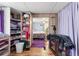 View from closet area into brightly lit, floral-themed bedroom; wood-look floors throughout at 11326 Minnieola Dr, New Port Richey, FL 34654