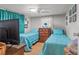 Comfortable bedroom featuring two twin beds, neutral wall color, and wood-look flooring at 11326 Minnieola Dr, New Port Richey, FL 34654