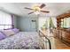 Bedroom with access to backyard featuring dresser, decorative items, and natural light at 11326 Minnieola Dr, New Port Richey, FL 34654