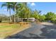 Charming home with lush landscaping, mature trees, and a driveway, offering privacy and curb appeal at 11326 Minnieola Dr, New Port Richey, FL 34654
