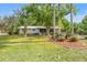 Well-maintained home with mature trees and lush greenery, providing a serene and private setting at 11326 Minnieola Dr, New Port Richey, FL 34654