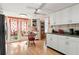 Eat-in kitchen with white cabinets, and a double door to the backyard at 11326 Minnieola Dr, New Port Richey, FL 34654