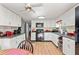 Kitchen features white cabinets, black appliances, and a ceiling fan at 11326 Minnieola Dr, New Port Richey, FL 34654