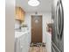 Bright laundry room features washer, dryer, door to outside, and ample storage at 11326 Minnieola Dr, New Port Richey, FL 34654