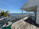Large balcony ideal for entertaining with table and chairs, offering picturesque views and white decorative railing at 121 Augusta Ave, Palm Harbor, FL 34683