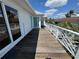 Exterior shot of wooden balcony overlooking a view of neighborhood homes at 121 Augusta Ave, Palm Harbor, FL 34683