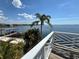 Gorgeous water view from the balcony of this home with a white decorative railing and a tropical vibe at 121 Augusta Ave, Palm Harbor, FL 34683