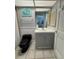 Bathroom featuring grey wainscoting, tile floors, and a sink with a vanity at 121 Augusta Ave, Palm Harbor, FL 34683