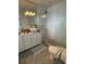 Well-lit bathroom with a glass shower, stone floors, and a sleek, modern toilet design at 121 Augusta Ave, Palm Harbor, FL 34683
