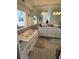 Bathroom features a soaking tub, pebble floor, double vanity, and ample lighting at 121 Augusta Ave, Palm Harbor, FL 34683