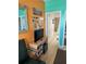Well-lit bedroom with desk, storage, and a view of a bathroom at 121 Augusta Ave, Palm Harbor, FL 34683