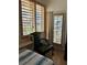 Cozy bedroom with natural light streaming through plantation shutters and tranquil waterfront view at 121 Augusta Ave, Palm Harbor, FL 34683